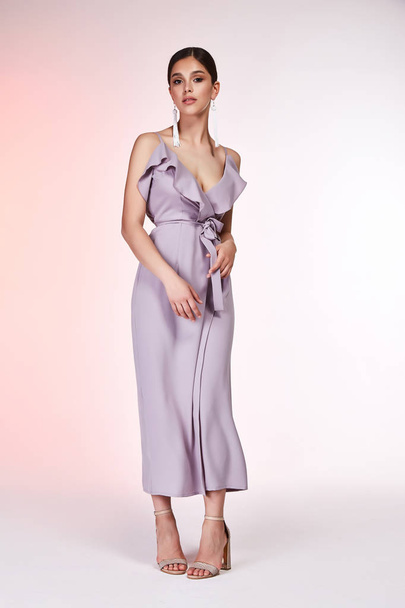 Pretty beautiful sexy elegance woman skin tan body fashion model glamor pose wear silk lilac dress casual clothes party summer collection makeup hair style brunette success accessory jewelry studio. - Fotó, kép