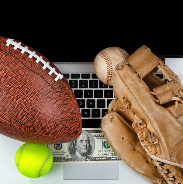 Sports equipment with computer and money for betting concept  - Foto, Imagem