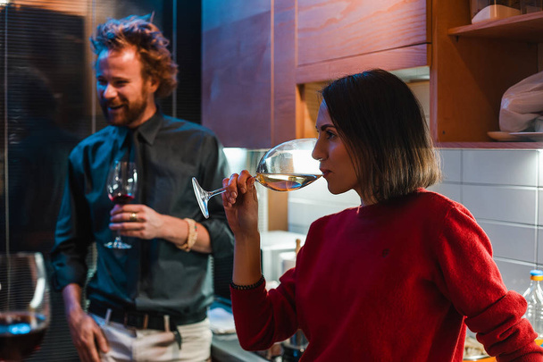 Young woman and man drinking wine on home party - Photo, Image