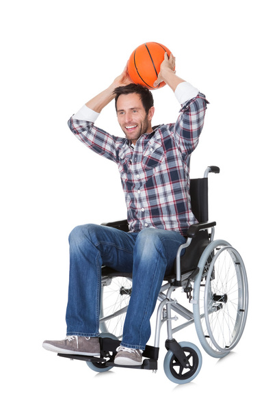 Man in wheelchair with basketball - Foto, Imagen