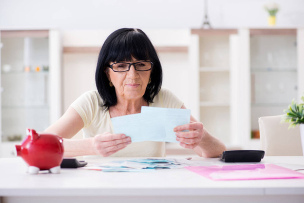 Mature woman trying to reconcile her bills - Photo, Image