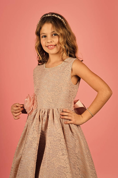 children model. Little girl in pink dress is posing in a beautiful studio. - Photo, Image
