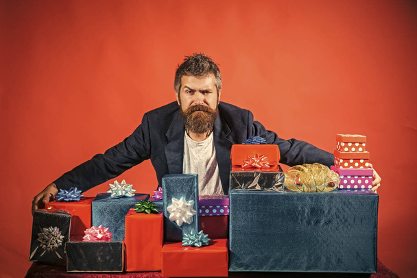 Christmas presents. Christmas man at present box on red background. - Фото, зображення
