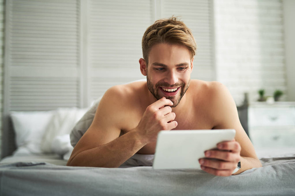 Delighted smiling male enjoying morning at home - Foto, imagen