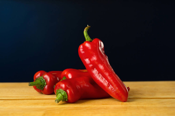 Red hot chili peppers, a fából készült háttér - Fotó, kép