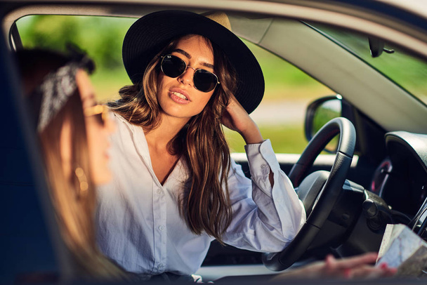 Dos mujeres jóvenes que se divierten conduciendo
 - Foto, imagen