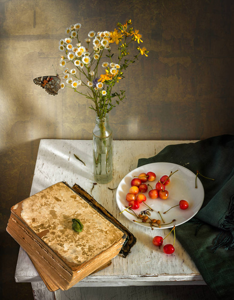 Still-life with flowers, a book, a cherry and a butterfly. Vintage. - Foto, Imagem