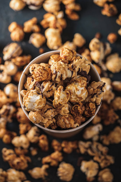 Diverse Popcorn in a paper cup against a dark background. Top view. - Photo, Image