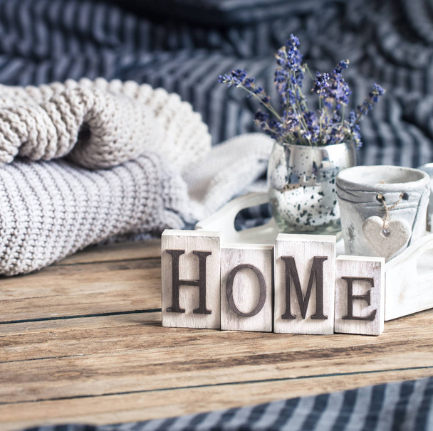 home decorations in the interior of a letter with an inscription home on a wooden background in the interior of the bedroom - Photo, Image