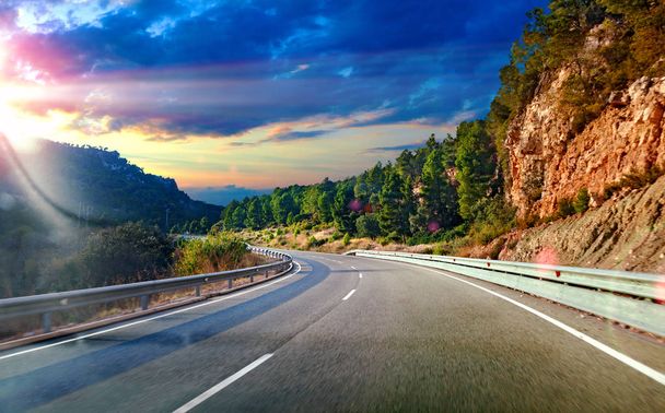 Road and travel concept.Sunset landscape and mountains.Highway to destiny.Tranquility and safety driving - Photo, Image