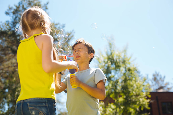 Content children blowing soap bubbles - Photo, Image
