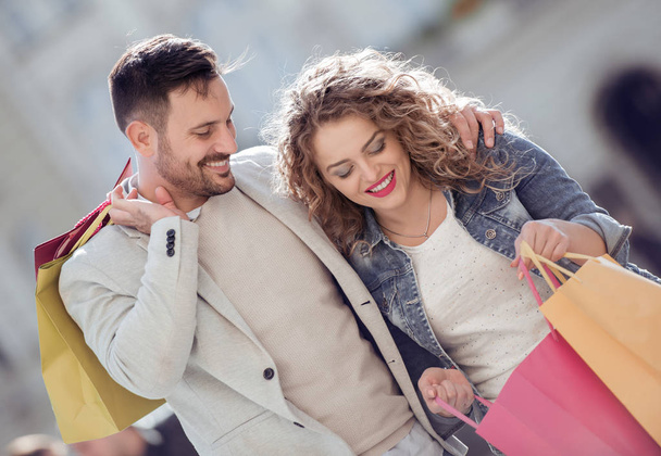 Portrait of happy couple with shopping bags. Sale, consumerism and people concept. - Photo, Image