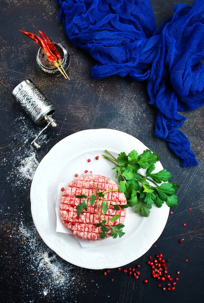 raw burgers on white plate with spice and salt - Fotografie, Obrázek