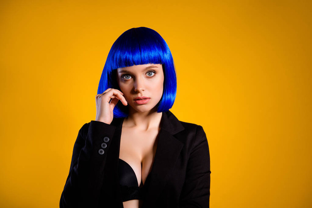 Portrait of fancy freak bitch in black jacket bright blue wig having baby-face big tits looking at camera isolated on yellow background. Salon hairdo hairdress concept - Zdjęcie, obraz