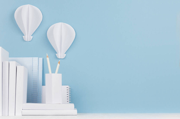 Modern style workplace - white stationery and decorative paper balloons on soft blue background and light desk. - Foto, Imagen