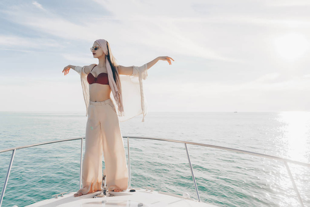 attractive stylish girl posing on a yacht, sailing the Caribbean sea and enjoying a vacation - Фото, изображение