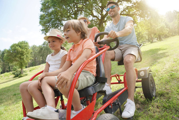 Family having a kart ride at the park - Fotoğraf, Görsel