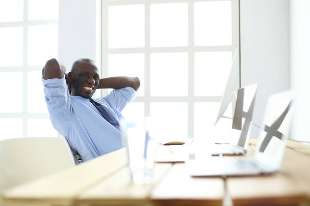 African american businessman on headset working on his laptop - Fotografie, Obrázek