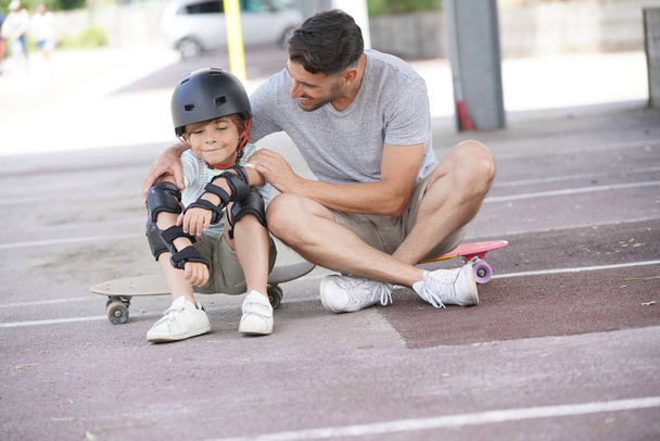 Portrait of daddy and son on skateboarding day - Foto, Bild