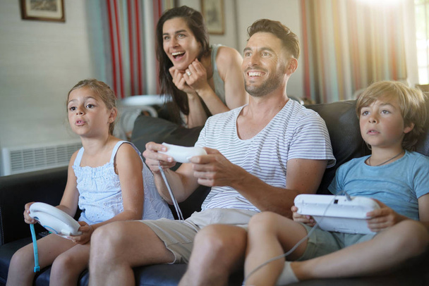 Family having fun at home playing video game - Фото, зображення