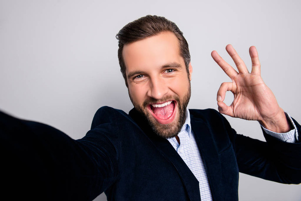 Done good perfect excellent agree like deal people concept. Close up portrait of cheerful excited handsome careless joyful freelancer showing okay symbol taking selfie isolated on gray background - Zdjęcie, obraz