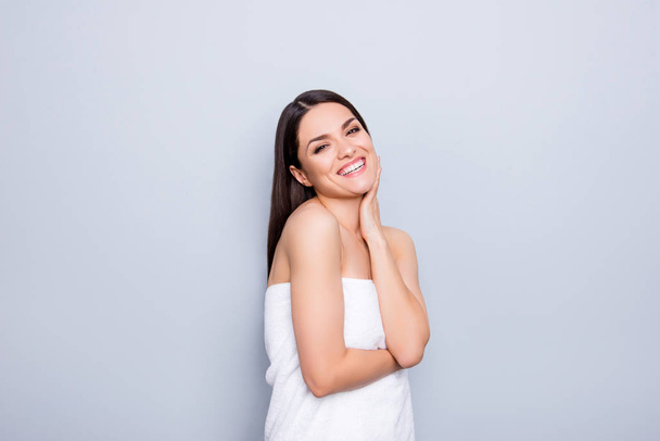 Cheerful funny positive toothy woman wrapped in white towel happy after procedure medical massage enjoying rest in spa center isolated on grey background wellness wellbeing concept - Valokuva, kuva