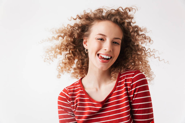 Close up portrait of smiling young girl with curly hair looking at camera isolated over white background - Photo, image