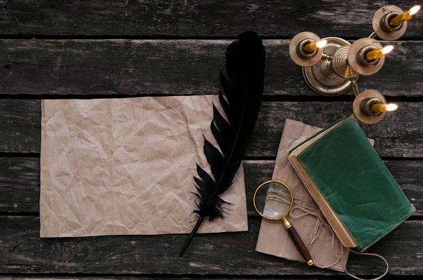 Blank crumpled paper page letter, magnifier, feather ink pen, diary book and wrapped in jute rope envelope on old table background. Old message. - Foto, Imagem