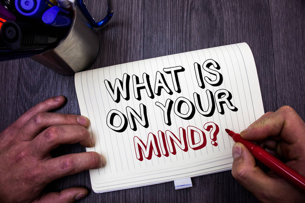 Conceptual hand writing showing What Is On Your Mind Question. Business photo showcasing Open minded thinks of intellectual innovation Man hold holding red marker notebook table messages ideas - Photo, Image