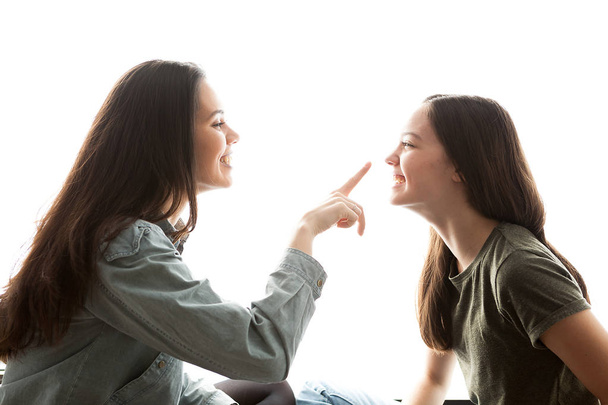 Two sisters playing with each other and having a great time - Фото, изображение