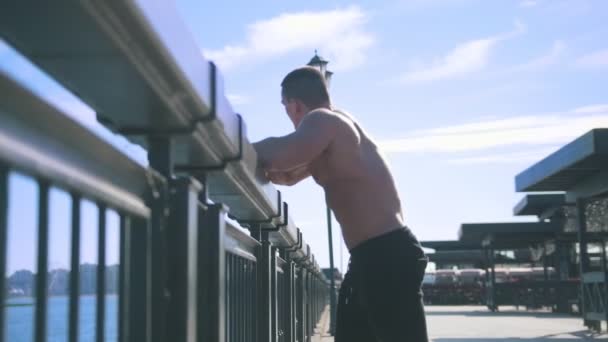 A muscular man looks to the sea - Footage, Video