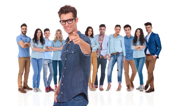 young casual leader with glasses wants you to be in his team, pointing finger while standing on white background - Photo, Image