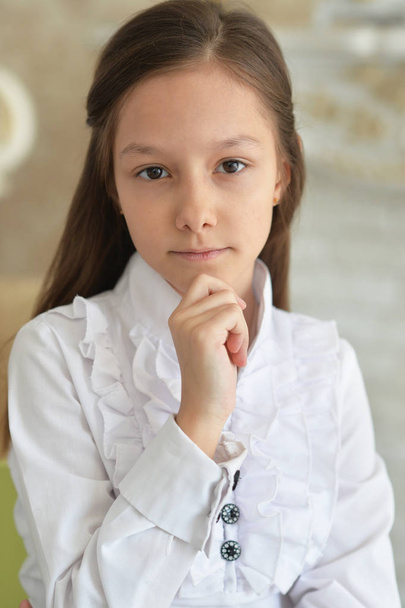 Emotional little girl in white blouse posing at home  - Foto, Imagem