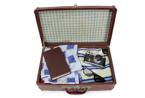 Vintage suitcase and old camera on a white background - Фото, изображение