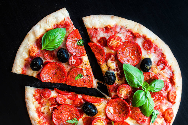 Traditional Italian Pepperoni pizza on dark background  - Valokuva, kuva