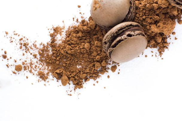 French biscuits macarons with carob powder on white background - Foto, Imagem