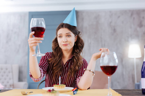 Woman making funny face while attending birthday party - Photo, image
