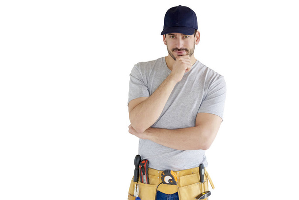 Portrait of handyman with hand on his standing at isolated white background with copy space. - Фото, изображение