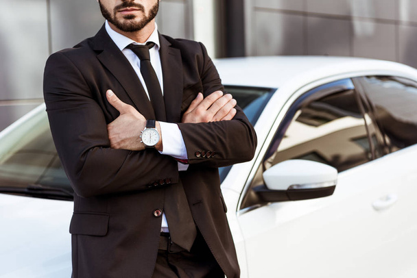 cropped image of businessman standing with crossed arms near car - Φωτογραφία, εικόνα