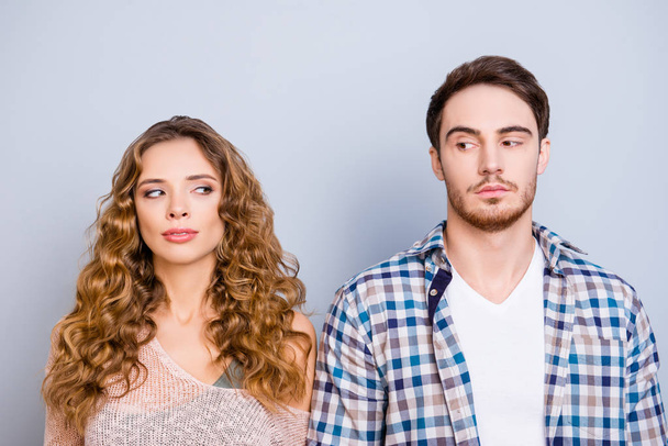 Conflict insult disagreement distrust fight cheat quarrel crisis concept. Portrait of modern couple in casual outfits looking at each other with eyes isolated on grey background - Photo, Image