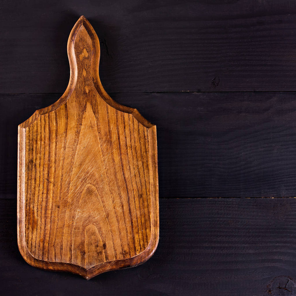 Cutting board on a dark background. Place for your text. - Photo, Image