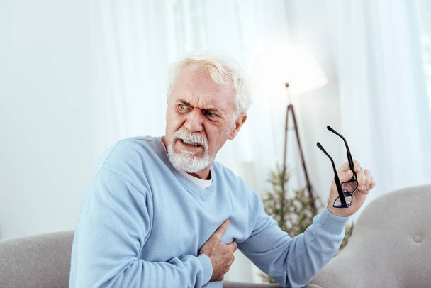 Concerned senior man having chest pain - Foto, Bild