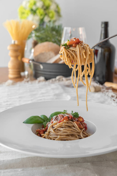Close up low angle view of a plate of spaghetti topped with deli - Photo, Image