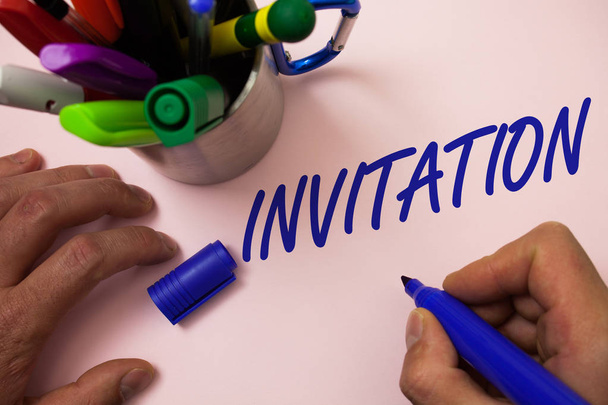 Handwriting text writing Invitation. Concept meaning Written or verbal request someone to go somewhere or do something Man working inspiration holding marker notebook ideas white background - Photo, Image