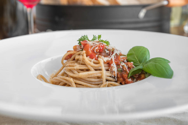 Closeup of spaghetti topped with delicious bolognaise sauce and basil - Fotoğraf, Görsel