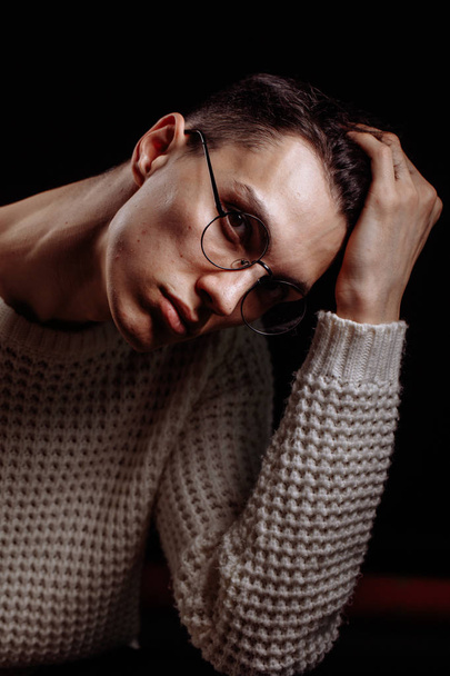 Studio shot of a handsome young male model wearing white T-shirt and sunglasses - 写真・画像