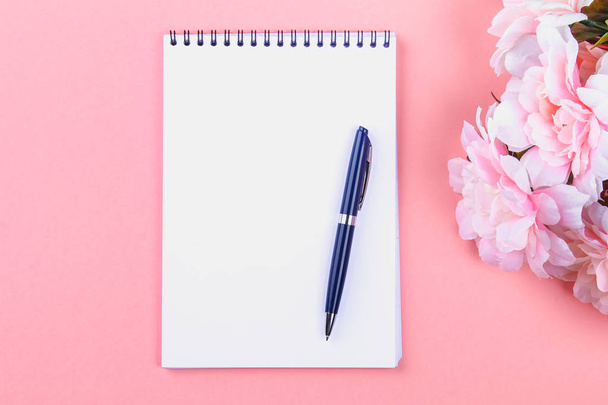 Empty notebook with blue pen on a pink pastel background. mock-up, frame, template - Fotografie, Obrázek