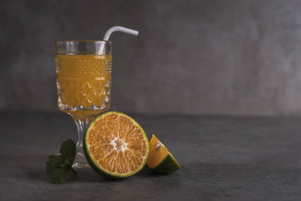 Fresh orange fruits and juice on stone table with copy space - Foto, Imagem