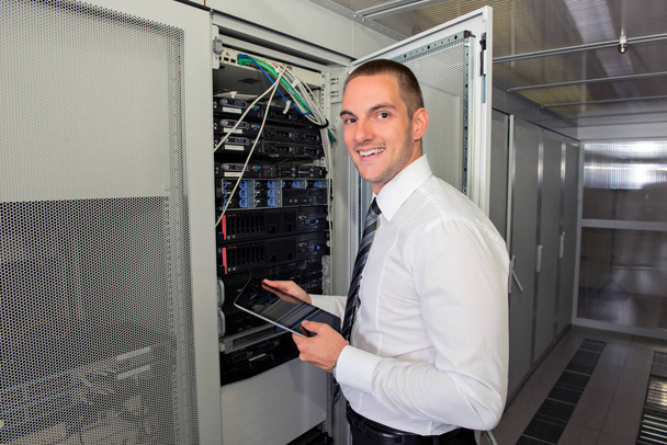 Young handsome business man engeneer in datacenter server room - Photo, Image