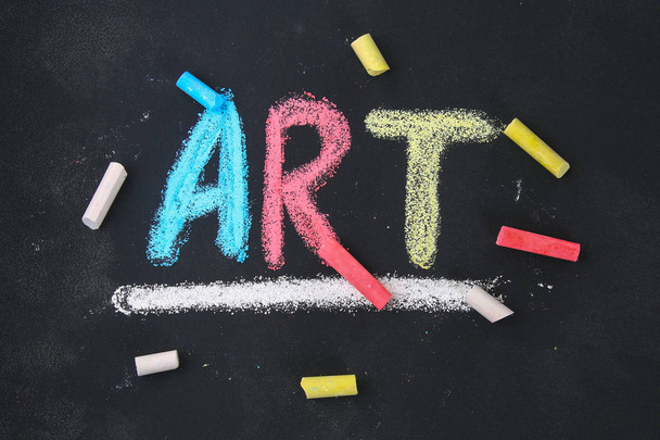 The text of the art is drawn with colorful chalk on a chalkboard - Фото, изображение